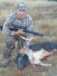 My son shot this nice boar 150 yards away.jpg